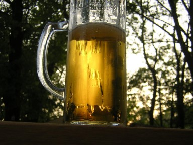Glas frisch gezapftes Bier auf Holztisch